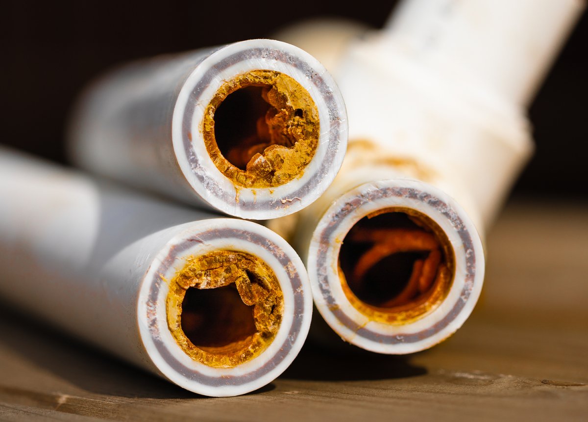 White mineral scale buildup on a bathroom faucet in a Southern Tier NY home caused by hard water