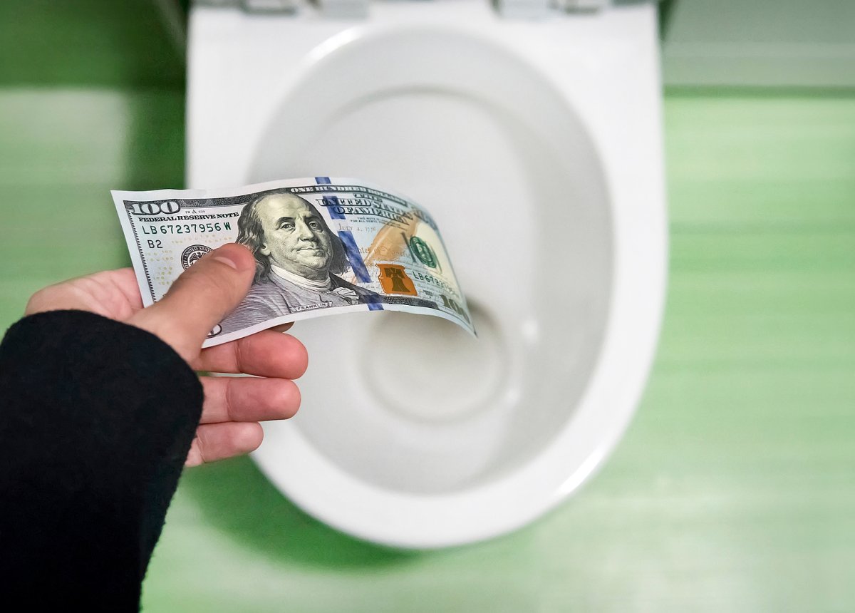 Licensed plumber repairing a running toilet in a Binghamton NY home bathroom