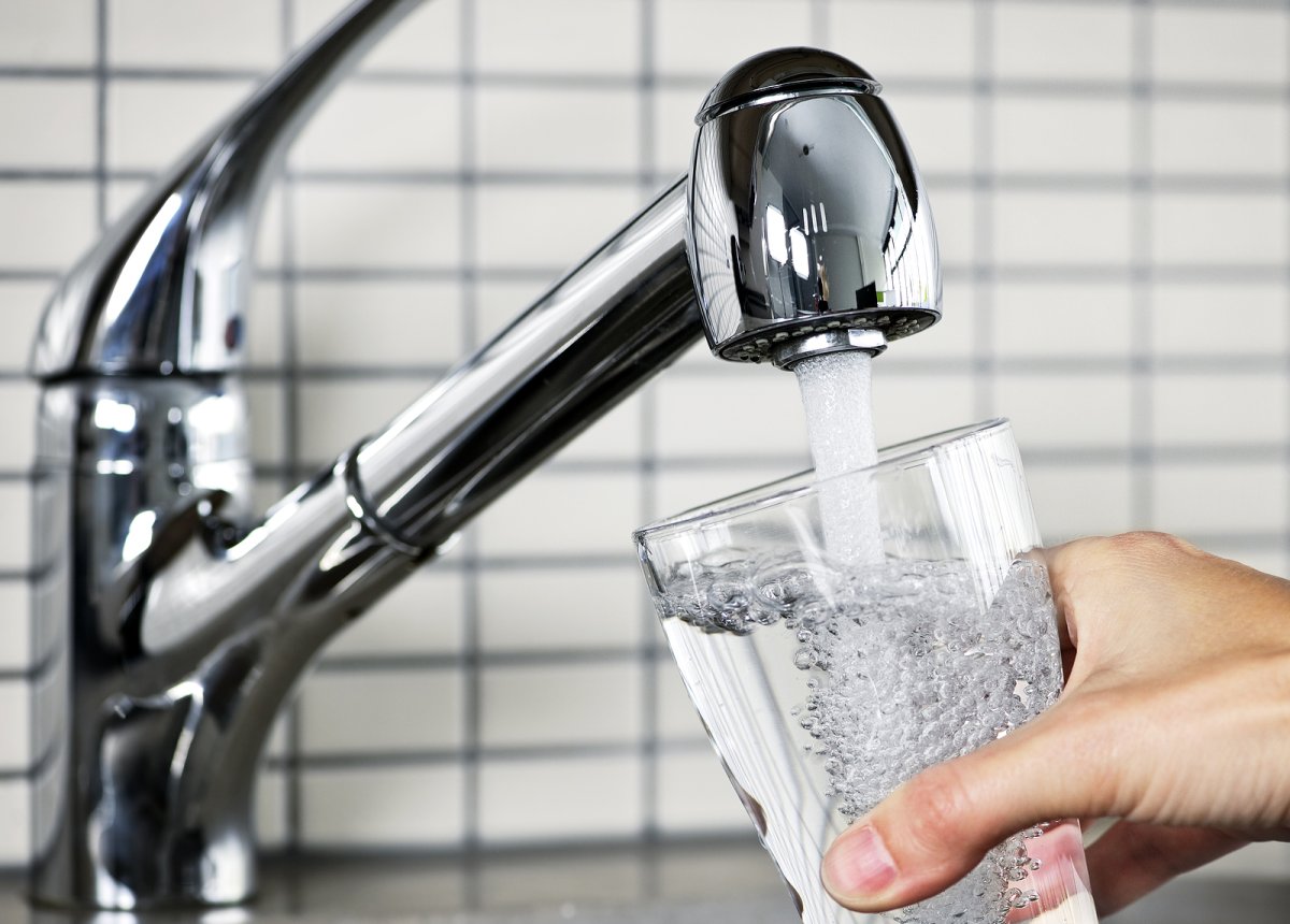 Homeowner testing tap water quality at a kitchen sink in a Southern Tier NY home